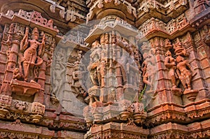 Exterior wall of temple ruins and beautifully carved stone sculpture of Hindu and Jain religion