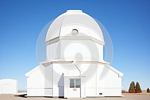 exterior of a white dome astronomical observatory under clear sky