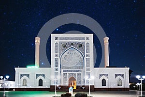 exterior of white Islamic Masjid Minor Mosque in Tashkent in Uzbekistan under night starry sky with stars