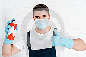 Exterminator in latex gloves holding toxic