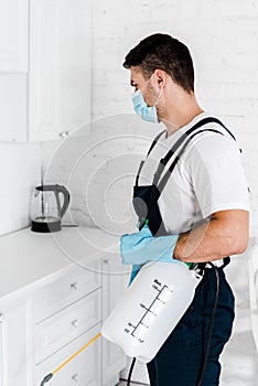 Exterminator in protective mask and uniform