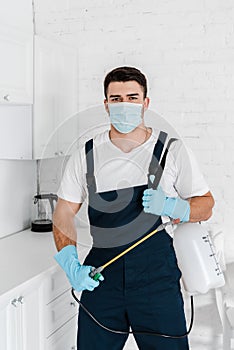 Exterminator in protective mask and uniform