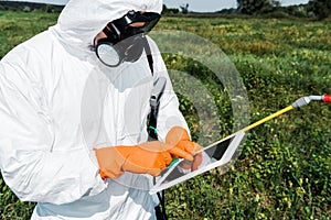 Exterminator in protective mask and uniform