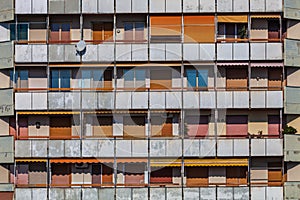 External facade of a popular building with apartments, balconies. The building appears worn out and needs to be restored