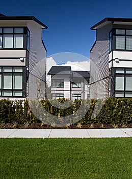 External facade of a row of colorful modern urban townhouses.brand new houses just after construction on real estate market