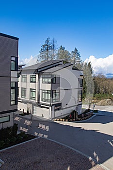 External facade of a row of colorful modern urban townhouses. brand new houses just after construction on real estate market