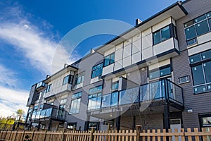 External facade of a row of colorful modern urban townhouses. brand new houses just after construction on real estate market photo