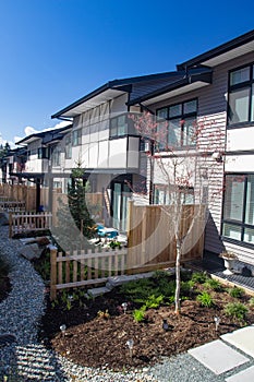 External facade of a row of colorful modern urban townhouses. brand new houses just after construction on real estate market