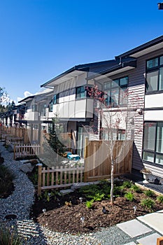 External facade of a row of colorful modern urban townhouses. brand new houses just after construction on real estate market