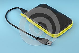 external hard drive, external drive with USB cable, on a blue background
