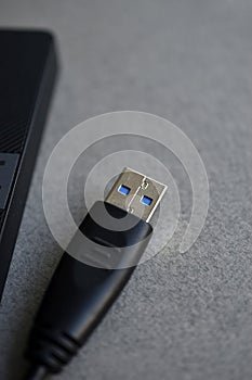 External hard drive with usb cable on a gray background