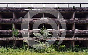 External of old abandoned building and was left to deteriorate over time and visible parts of structural elements and ruins