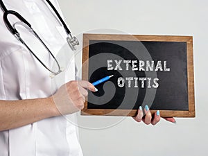 EXTERNAL OTITIS Swimmer`s Ear Otitis Externa sign on the chalkboard