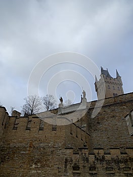 External walls of the Hohenzollern Castle with entrance and tower inthe bachground
