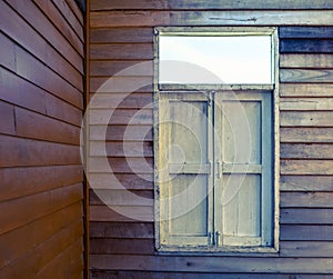 The external wood window and wall of a vintage wood house