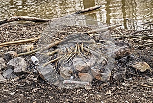 Extinguished fire beside a river