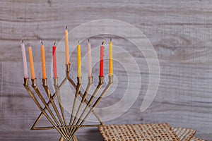 Extinguished Hanukkah candles and smoke. Stack of molten wax in cups with menorah