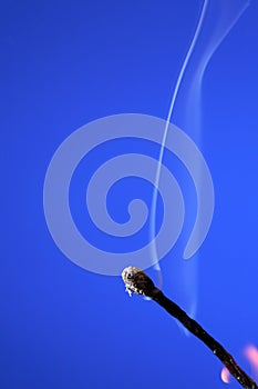 Extinguished Match On Blue