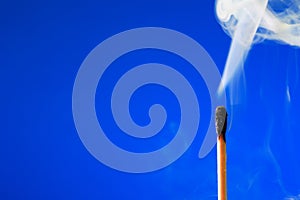 Extinguished Match On Blue