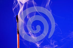 Extinguished Match On Blue