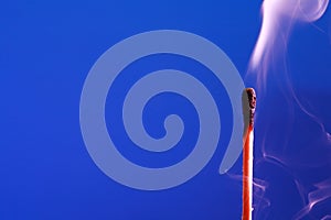 Extinguished Match On Blue