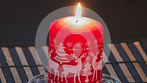 Extinguished red candle isolated on white background