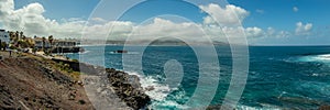 Extra large panorama from La Isleta an warm sunny day with briht blue sky and white clouds. Las Palmas, Las Canteras beach, Gran