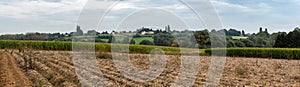 Extra large panoramic view of harvested farmland with cornfields an potato fields