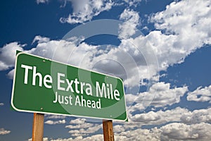 The Extra Mile Just Ahead Green Road Sign Over Sky