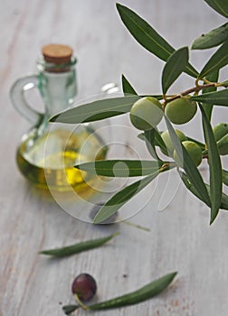 Extra-virgin olive oil bottle and green olivas photo