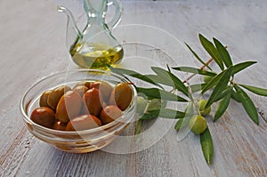 Extra-virgin olive oil bottle and green olivas photo