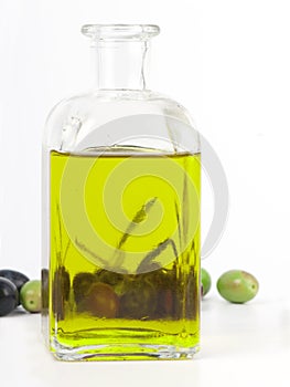 Extra virgin olive oil with fresh olives. photo