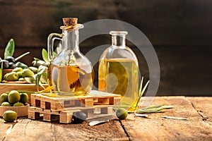 Extra virgin olive oil in glass bottles on a wooden background. Healthy and detox food concept. place for text