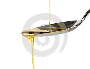 Extra virgin olive oil pouring over a spoon isolated on white background