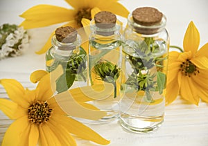 Extract, flowers, ingredient bottle natural herbal aromatherapy a white wooden background