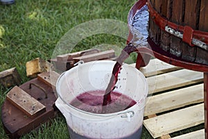 Extracting grape juice with old manual wine press