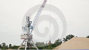 Extraction of river sand by a port crane, production