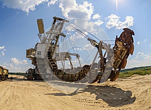 Extraction of sand in the quarry of a huge excavator