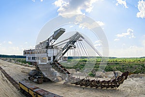 Extraction of sand in the quarry of a huge excavator