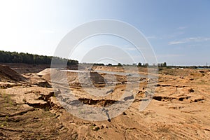 Extraction in a sand quarry with powerful machines and a washing lake