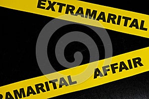 Extramarital affair crime scene, caution and warning concept. Yellow barricade tape with word in black background.