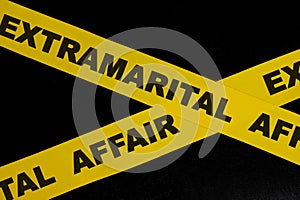 Extramarital affair crime scene, caution and warning concept. Yellow barricade tape with word in black background.