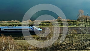 Extraordinary High Speed Passenger Train Passing a Lake and Forest