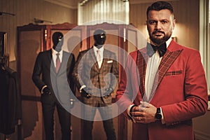 Extravagant stylish man in tailor studio photo
