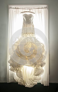 Extravagant wedding dress in window photo