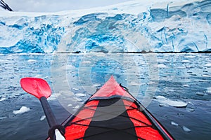 Extreme adventure sport, Antarctica kayaking, paddling on kayak between antarctic icebergs