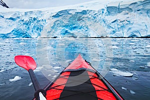 Extreme adventure sport, Antarctica kayaking, paddling on kayak between antarctic icebergs photo