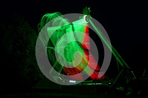 Extreme attraction in Lunapark, with a multi-colored red and green lights, a long exposure shooting photo