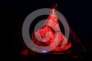 Extreme attraction in Lunapark, with a multi-colored red and white lights, long exposure shooting in dark in motion