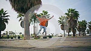 Extreme boy riding skateboard on city park. Guy skateboarder practicing skating.